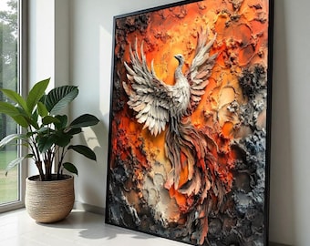May include: A framed artwork depicts a phoenix rising from flames. The bird is rendered in shades of white and gray, with outstretched wings and a flowing tail. The background features textured layers of orange, red, and black, creating a dramatic effect. The artwork is displayed in a black frame.