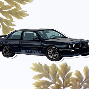 May include: A black car sticker featuring a cartoon illustration of a black BMW E30 with the words "Killer Speed" on the side.