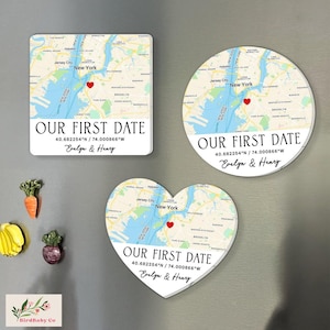 May include: Three custom magnets with a map design. One is square, one is round, and one is heart-shaped. Each features a map of New York City with a red heart marking a location, the text "OUR FIRST DATE", coordinates, and names.