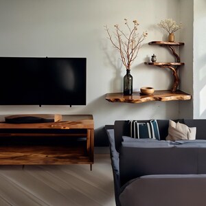 May include: A dark wood TV stand with two shelves and a dark wood floating shelf with a vase of dried branches and a bowl. A dark gray couch with pillows is in the background.