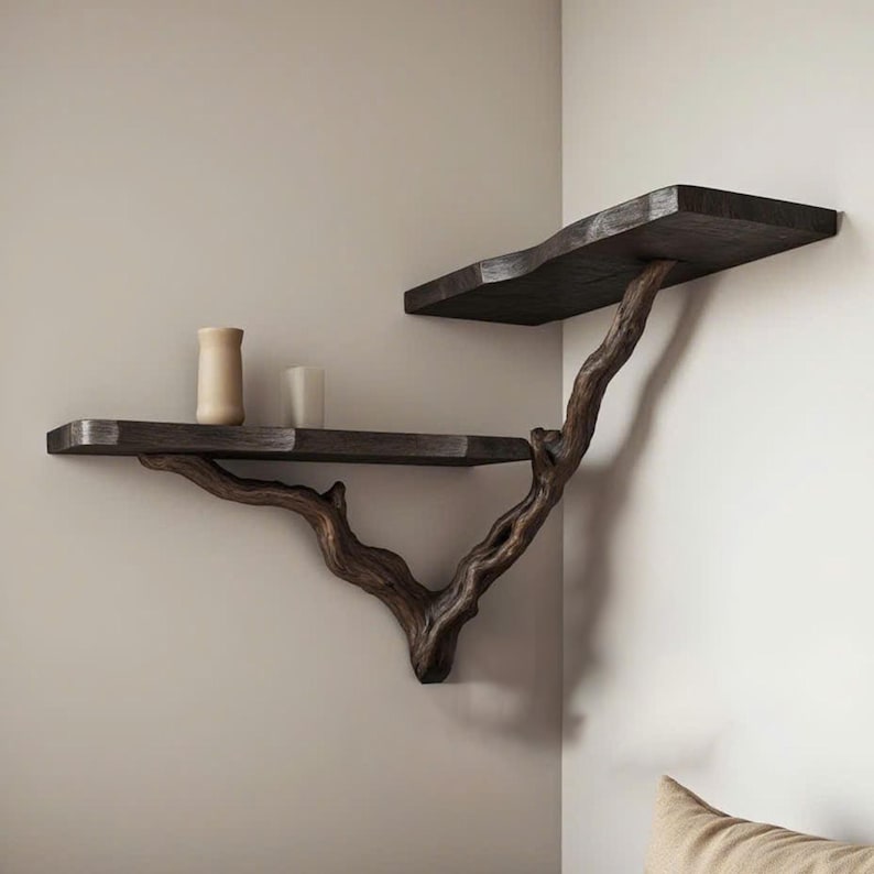 May include: A set of two wooden shelves mounted on a wall, with a natural branch design. The shelves are dark brown and have a rustic, organic look.