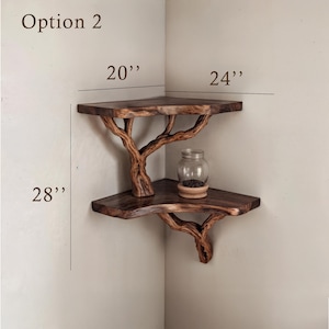 May include: A two-tiered corner shelf made from wood with a natural branch design. The shelf is 20 inches wide, 24 inches deep, and 28 inches tall.