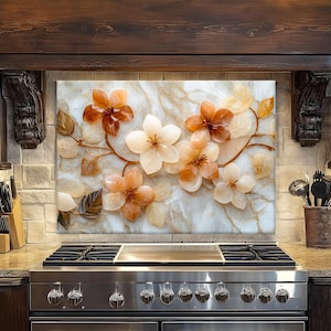 May include: A decorative kitchen backsplash featuring a floral design with orange and white flowers and leaves. The flowers are set against a marble-like background, creating a natural and elegant aesthetic. The backsplash is installed above a stainless steel gas range.