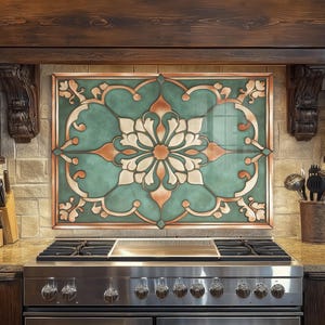 May include: A decorative kitchen backsplash with a floral design. The backsplash features a teal background with a large white and orange flower in the center. The design is framed with a copper-colored border. The backsplash is above a stainless steel gas range.