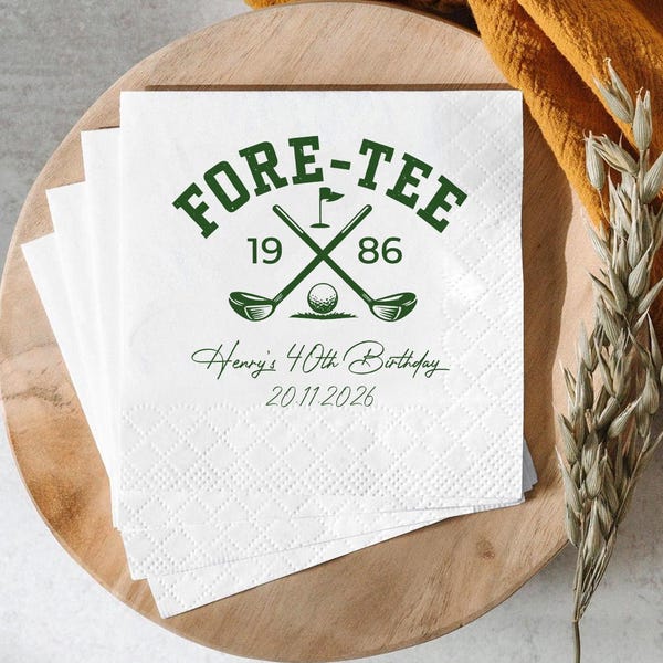 May include: A stack of white paper napkins featuring a green graphic of two crossed golf clubs, a golf ball, and a flag. The text reads FORE-TEE, 19 86, Henry's 40th Birthday, and 20.11.2026. The napkins have a textured, embossed diamond pattern.