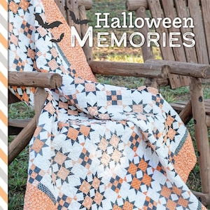 May include: A quilt with a black, white, and orange patchwork design featuring stars and squares. The quilt is draped over a wooden chair with two pumpkins in the foreground. The text "Halloween Memories" is displayed above the quilt and "By Susan Ache" is displayed below the quilt.