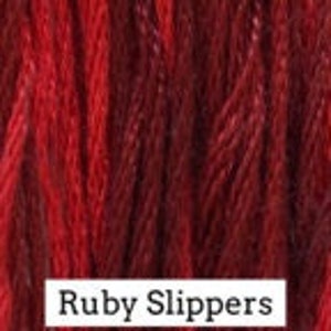 May include: A skein of deep red embroidery floss, labeled "Ruby Slippers".