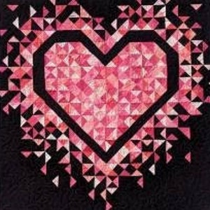 May include: A black and pink quilt with a heart design. The heart is filled with pink triangles and outlined in black. The quilt is labeled "MINI Exploding Heart" and "Slice of π Quilts".