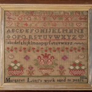 May include: A framed sampler with an alphabet, numbers, and a floral design. The sampler is dated 1834 and signed "Margaret Lunt's work aged to years".