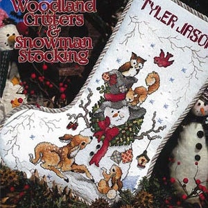 May include: A white stocking with a snowman, deer, and owl design. The stocking is personalized with the name "Tyler Jason".