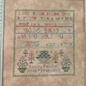 May include: A framed cross-stitch sampler with the text "Louisa Fletcher Aged 9 Years 1860" and a colorful alphabet. The sampler is 150 x 160 stitches and was stitched on 40 count verdal Twila fabric. The design is by Rebel Stitcher Designs.