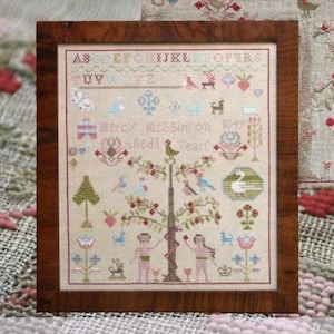 May include: A cross-stitch sampler titled "Mercy Megginson 1849" with a tree, birds, and flowers. The sampler is framed in a dark wood frame. The text "ABCDEFGHIJKLELOPERS UV mercy 65infon (0)" is stitched on the sampler.