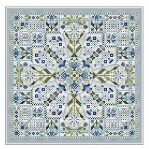 May include: A cross-stitch pattern titled "The Winter Window" with a symmetrical design in shades of blue, green, and white. The pattern includes floral and geometric elements. The finished stitch count is 117W x 117H. Designed by Carolyn Manning Designs.