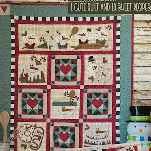 May include: A handmade quilt with a winter theme. The quilt features various squares with snowman and heart designs, along with the text "1 Cute Quilt and 10 Sweet Recipes". The color palette includes red, green, and cream.