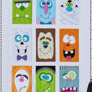 May include: A Halloween-themed quilt featuring nine colorful monster faces. The quilt has a white background with orange and black borders. Each monster has a unique design, including Frankenstein, a vampire, and a mummy.