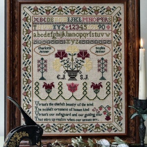 May include: A framed cross-stitch sampler with a floral design and a poem about virtue. The poem reads: "Virtue's the chiefelt beauty of the mind, The nobleft ornament of human kind, Virtue's our safeguard and our guiding star, That stirs up reason when our senses err."