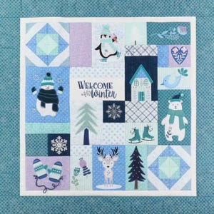 May include: A patchwork quilt with a winter theme. It features squares with images of a snowman, penguin, polar bear, mittens, and a deer. The text "Welcome Winter" is displayed in the center. The color palette includes shades of blue, white, and purple.