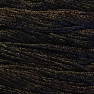 May include: A close-up of a spool of black embroidery floss.