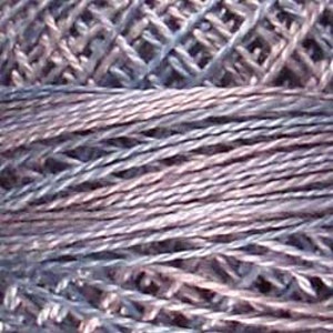 May include: Close-up of a ball of yarn in shades of gray and blue. The yarn appears to be a fine, textured thread, with visible strands and a slightly iridescent sheen. The image highlights the intricate details of the yarn.