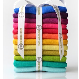 May include: A stack of colorful felt squares in a rainbow of hues, from turquoise to purple, bound with a white ribbon printed with "suespargo.com". The text "Bundle shown is for illustration only!" is at the bottom.