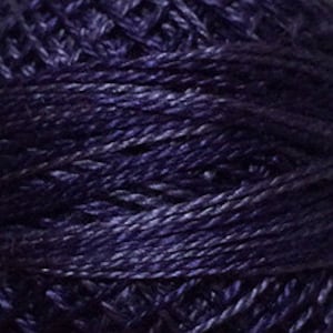 May include: Close-up of a ball of dark indigo yarn. The yarn appears to be a blend of fibers, with subtle variations in color and texture. The yarn is tightly wound, showing the individual strands.