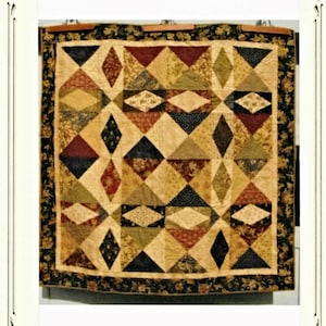 May include: A quilt pattern titled "Refraction" by Deb Eggers. The quilt features a geometric design with a variety of fabrics in shades of brown, green, red, and black. The quilt is framed with a black floral border. The text "the cottage rose" and "Pattern Originals" is printed above the quilt. The text "CR1451" is printed in the bottom right corner.