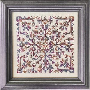 May include: Framed cross-stitch artwork featuring a symmetrical, geometric design. The needlework uses a variety of colors, including burgundy, purple, blue, and gold, on a cream-colored background. The frame is a dark gray color.