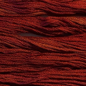 May include: Close-up of a bundle of brown embroidery floss. The threads are tightly wound and have a slightly textured appearance. The color varies from a deep reddish-brown to lighter shades, creating a subtle gradient effect. Ideal for various craft projects.