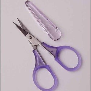 May include: Purple handled scissors with a silver blade and a purple plastic case.