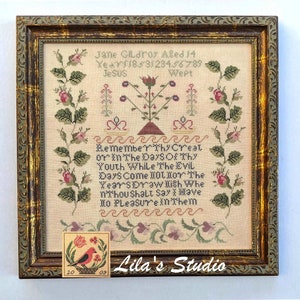 May include: A framed cross-stitch sampler featuring a floral design and the text "Remember Thy Creat or in The Days Of Thy Youth While The Evil Days Come 100l lor The Years Draw Ilish Whe nthou shalt Say X Mave Ho Pleasure in Them". The sampler is in a brown frame with a gold trim. There is a small, framed cross-stitch sampler with a bird and flowers in the bottom right corner.