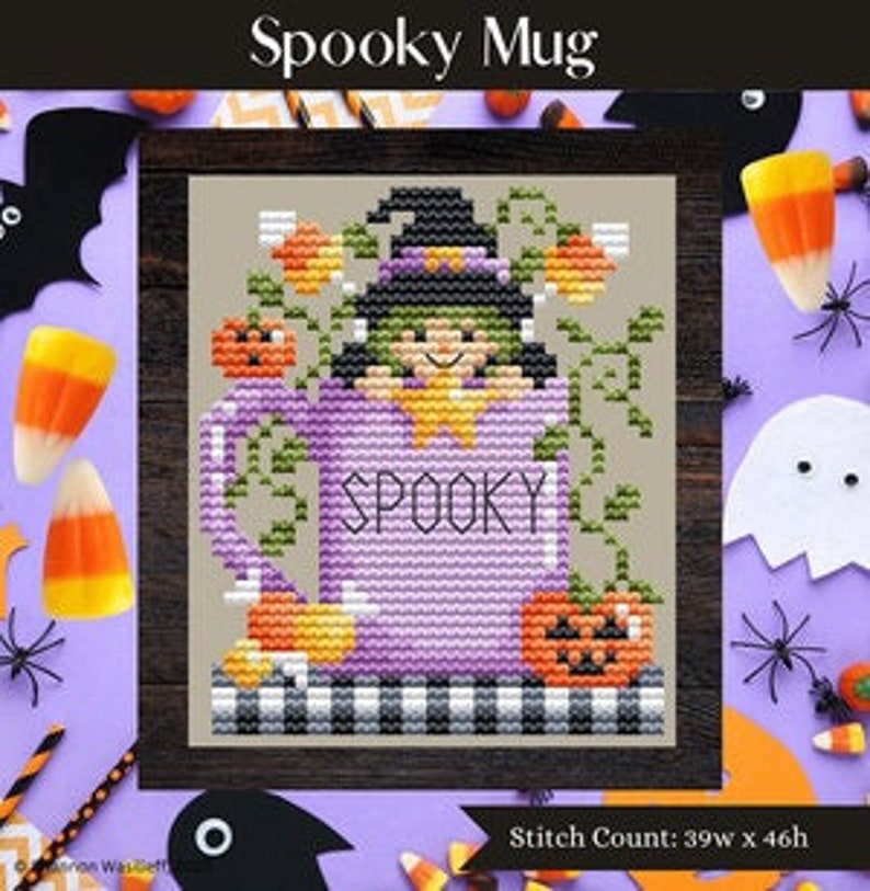 May include: Cross stitch pattern of a purple mug with the word "SPOOKY" on it. A witch with a green hat and dress is inside the mug. There are pumpkins and candy corn around the mug. The stitch count is 39w x 46h.