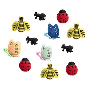 May include: Assortment of colorful plastic buttons featuring various insects and butterflies. The buttons include a ladybug, a bee, an ant, and a butterfly. The buttons are all different sizes and shapes.