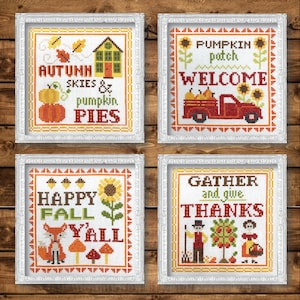 May include: Four framed cross-stitch embroidery designs with autumn themes. The designs feature phrases like "Autumn Skies & Pumpkin Pies", "Pumpkin Patch Welcome", "Happy Fall Y'all", and "Gather and Give Thanks".
