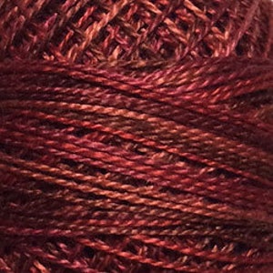 May include: A spool of red and brown embroidery floss.