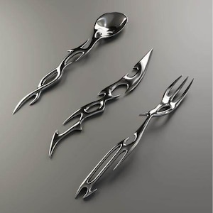 May include: A set of three polished silver-toned metal utensils consisting of a spoon, a knife, and a fork. Each piece features an elongated, pointed handle with intricate, open-work cutouts and sharp, flame-like edges along the entire length.