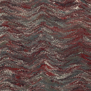 Puede incluir: Primer plano de un papel marmoleado con un patrón ondulado en tonos rojos, verdes y blancos.