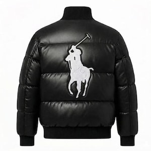 May include: A black puffer jacket featuring a large white embroidered logo of a polo player on a horse on the back. The jacket has a high collar, long sleeves with ribbed cuffs, and a ribbed hem, constructed with horizontal quilted panels.