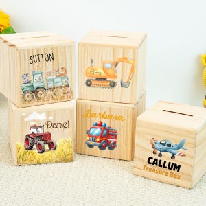 May include: Wooden treasure boxes with various vehicle designs. One box features a train with the name "Sutton", another an excavator with "Gerry", a tractor with "Daniel", a fire truck with "Barbara", and a plane with "Callum Treasure Box".