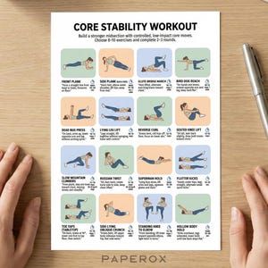 May include: A white printed sheet with a core stability workout guide, including exercises like front plank and side plank. A silver pen rests on a wooden surface next to the sheet. The text reads "Core Stability Workout".