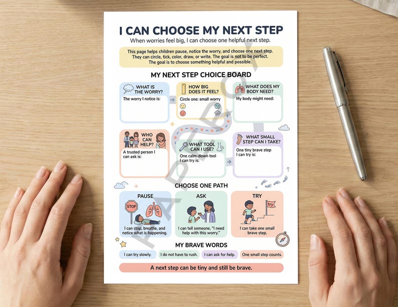 May include: A printed educational chart titled "I Can Choose My Next Step" with colorful illustrations and text. The chart is designed to help children manage worries and make choices. A silver pen rests on the wooden surface.