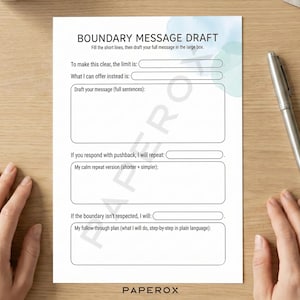 May include: A white paper titled "BOUNDARY MESSAGE DRAFT" with fill-in-the-blank sections for setting boundaries. A silver pen rests on a light wood surface next to the paper. The paper includes sections for limits, offers, and follow-through plans.
