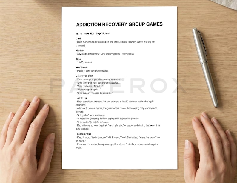 Puede incluir: Una hoja de papel blanca con el t&iacute;tulo "ADDICTION RECOVERY GROUP GAMES" e instrucciones para una actividad grupal. Un bol&iacute;grafo plateado descansa en el lado derecho del papel. El papel est&aacute; sobre una superficie de madera marr&oacute;n claro.