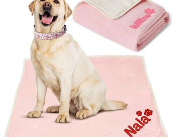 May include: A pink dog bed with a white border and the name "Nala" embroidered in red. A yellow Labrador Retriever is sitting on the bed. The bed is made of soft, plush fabric.