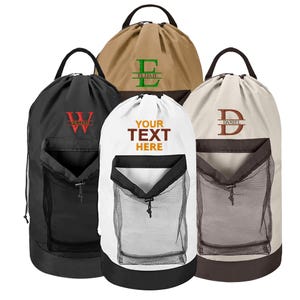 May include: Four drawstring laundry bags with a mesh pocket on the front. The bags are in black, white, beige, and brown. The bags are personalized with the names "William", "Elijah", "Daniel", and "Your Text Here".
