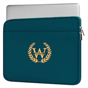 May include: Teal laptop sleeve with a gold-colored emblem featuring the letter "W" and the name "WILLIAM". The sleeve has a zipper closure and a laptop peeking out from the top. The sleeve is designed to protect a laptop.