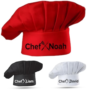May include: Three red, black, and white chef hats with the word "Chef" and a name printed on each. The hats are all the same style, with a tall, rounded crown and a wide brim.