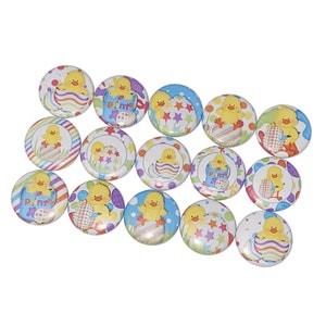 May include: A set of 14 round, colorful buttons featuring a cartoon chick in an Easter egg. The buttons have a variety of designs, including polka dots, stripes, and stars.