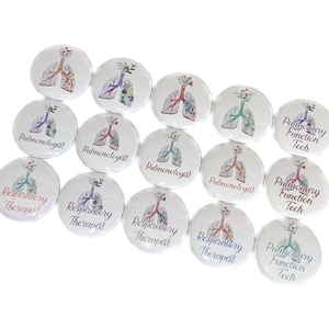 May include: A collection of 12 round buttons with a white background and colorful floral designs. The buttons feature different medical professions, including "Pulmonary Function Tech" and "Respiratory Therapist".