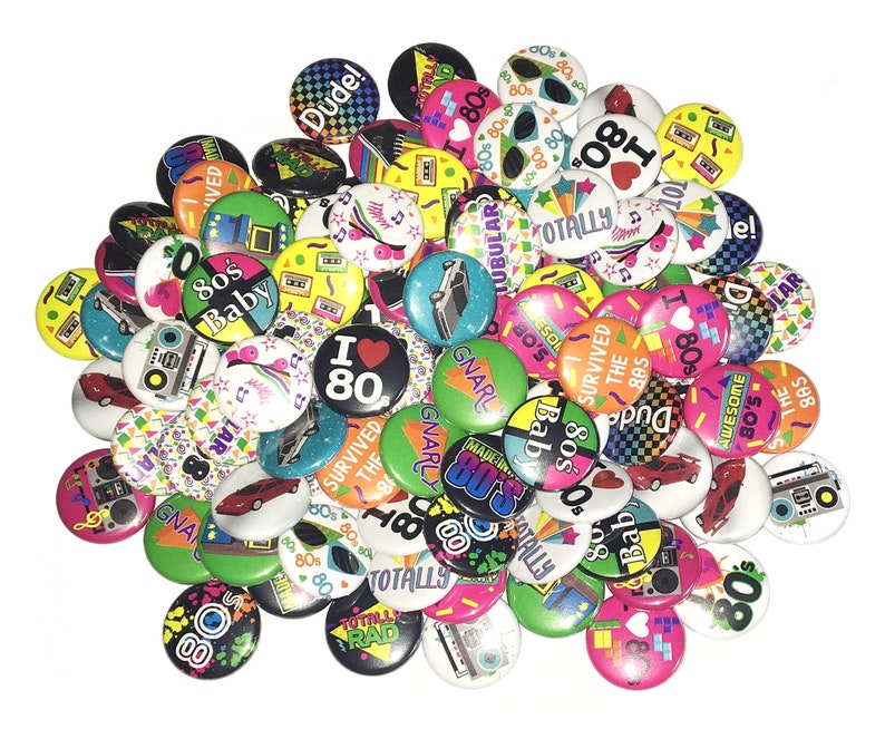 May include: A collection of colorful 80s themed buttons with various designs and slogans, including "I Love 80s", "Totally Rad", "Survived the 80s", "Gnarly", and "80s Baby".