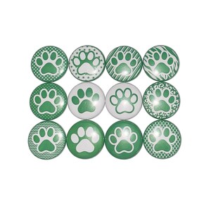 May include: Twelve green and white paw print buttons with different patterns. The paw prints are white and the background is green.